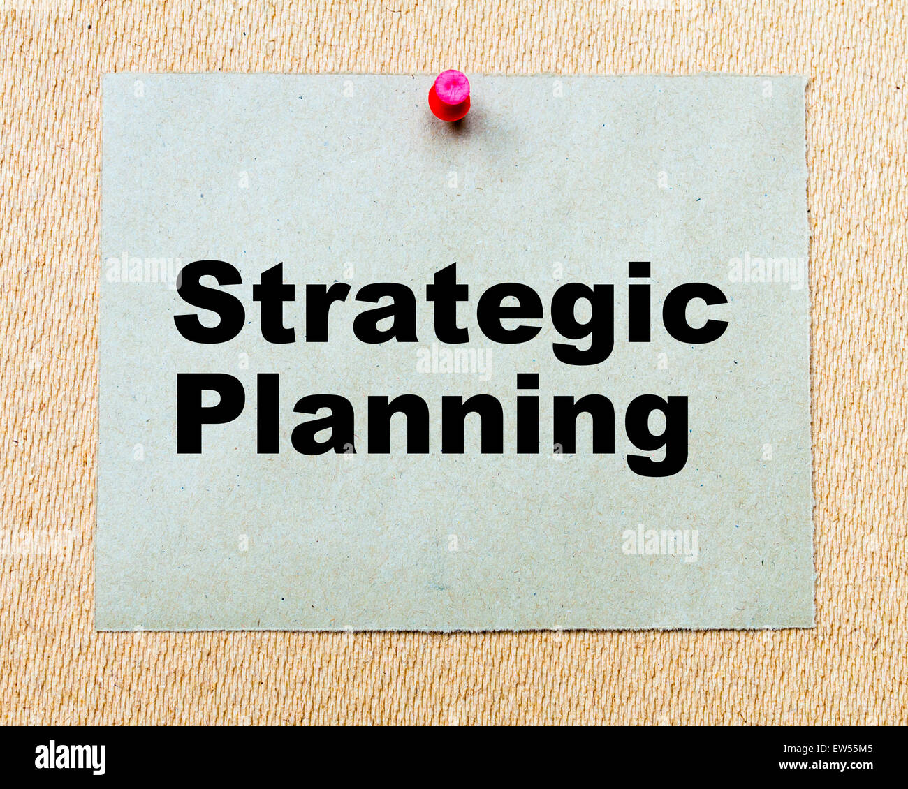 Strategic Planning written on paper note pinned with red thumbtack on wooden board. Business conceptual Image Stock Photo