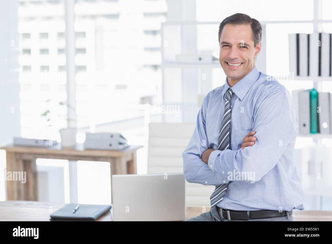 Smiling businessman looking at camera Stock Photo - Alamy