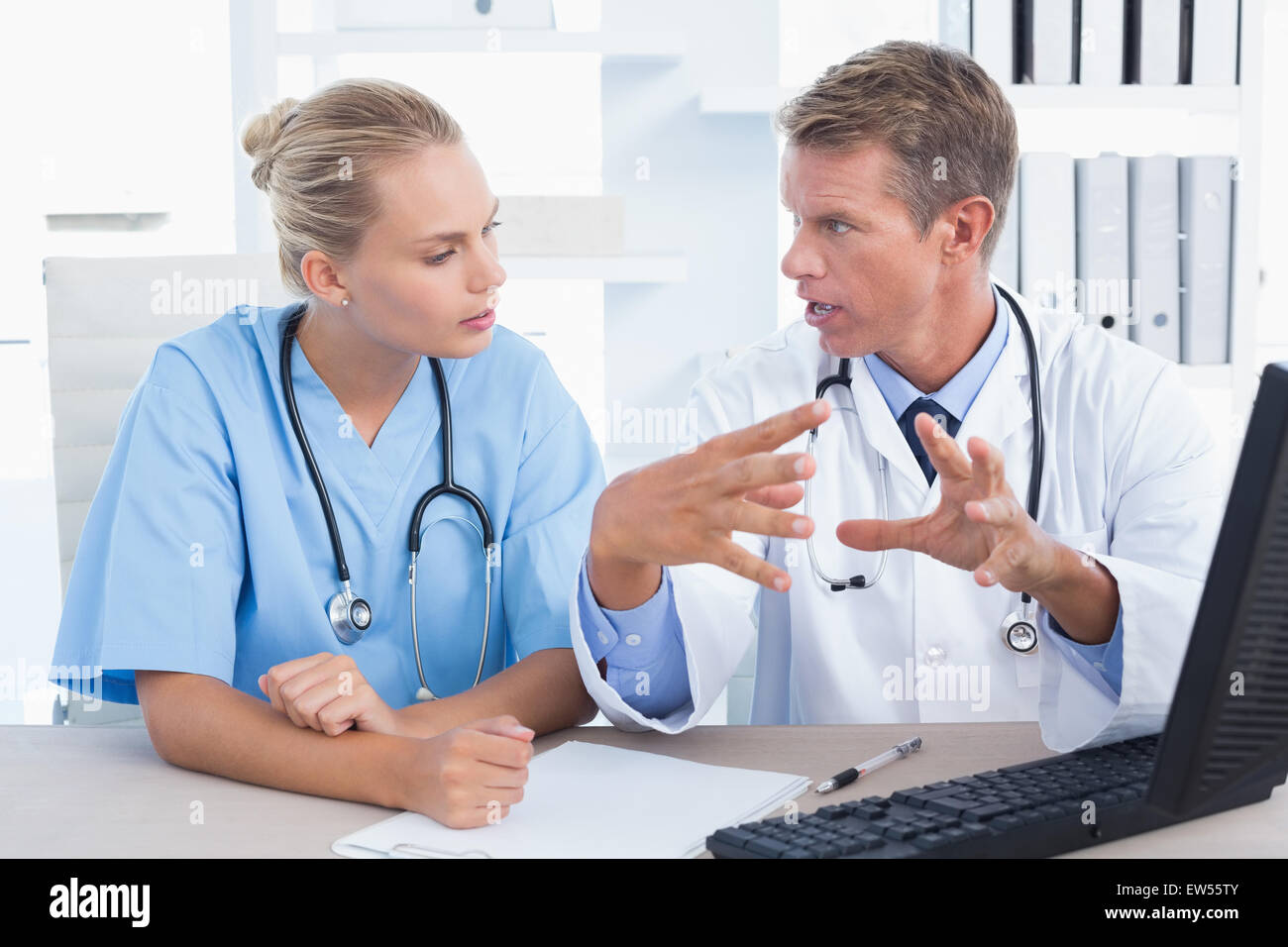 Concentrated doctor and nurse speaking in medical office Stock Photo Alamy