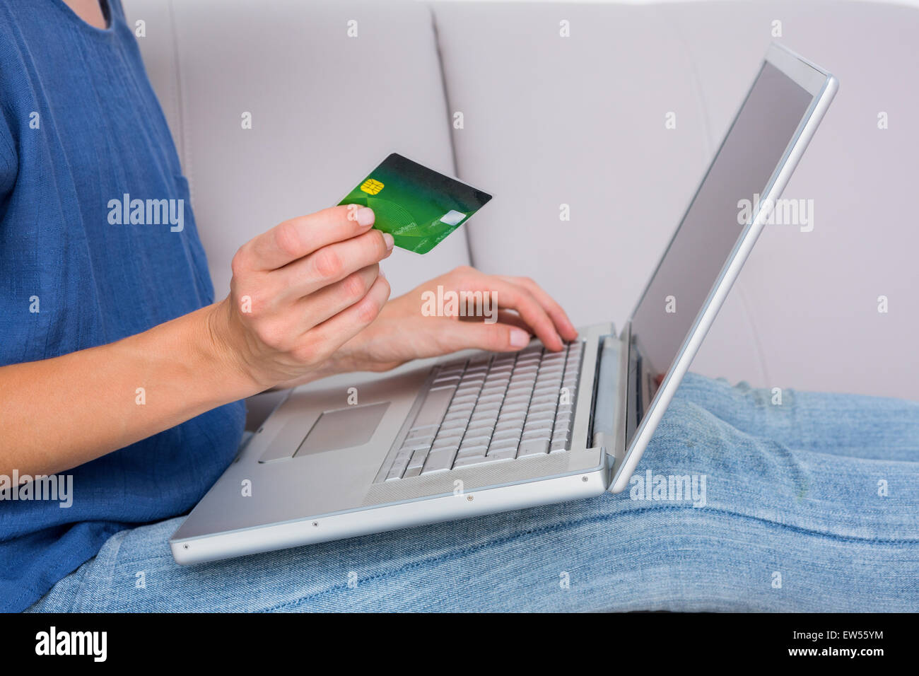 Woman doing online shopping with laptop and credit card Stock Photo