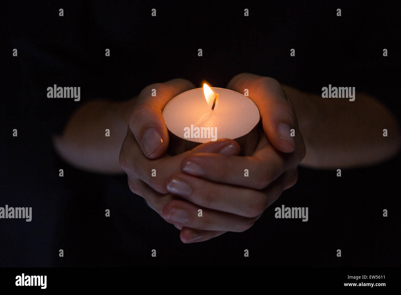 Hands holding candle Stock Photo
