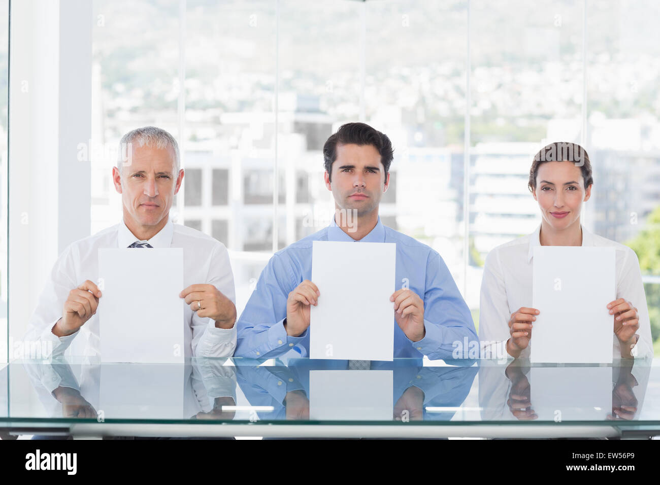 Smiling business team showing paper Stock Photo