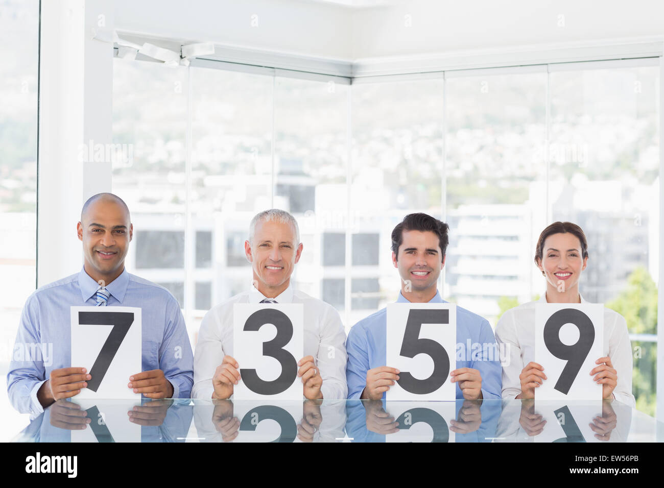 Smiling business team showing paper with rating Stock Photo