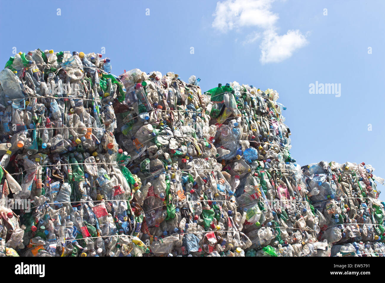 Stack of plastic bottles for recycling against blue sky Stock Photo - Alamy