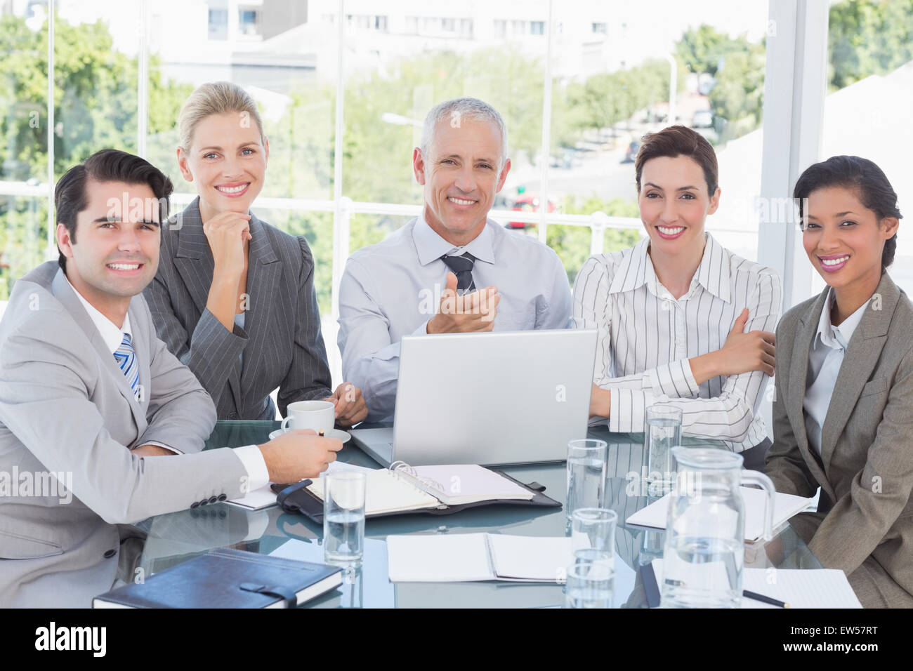 Happy business team working at desk together Stock Photo