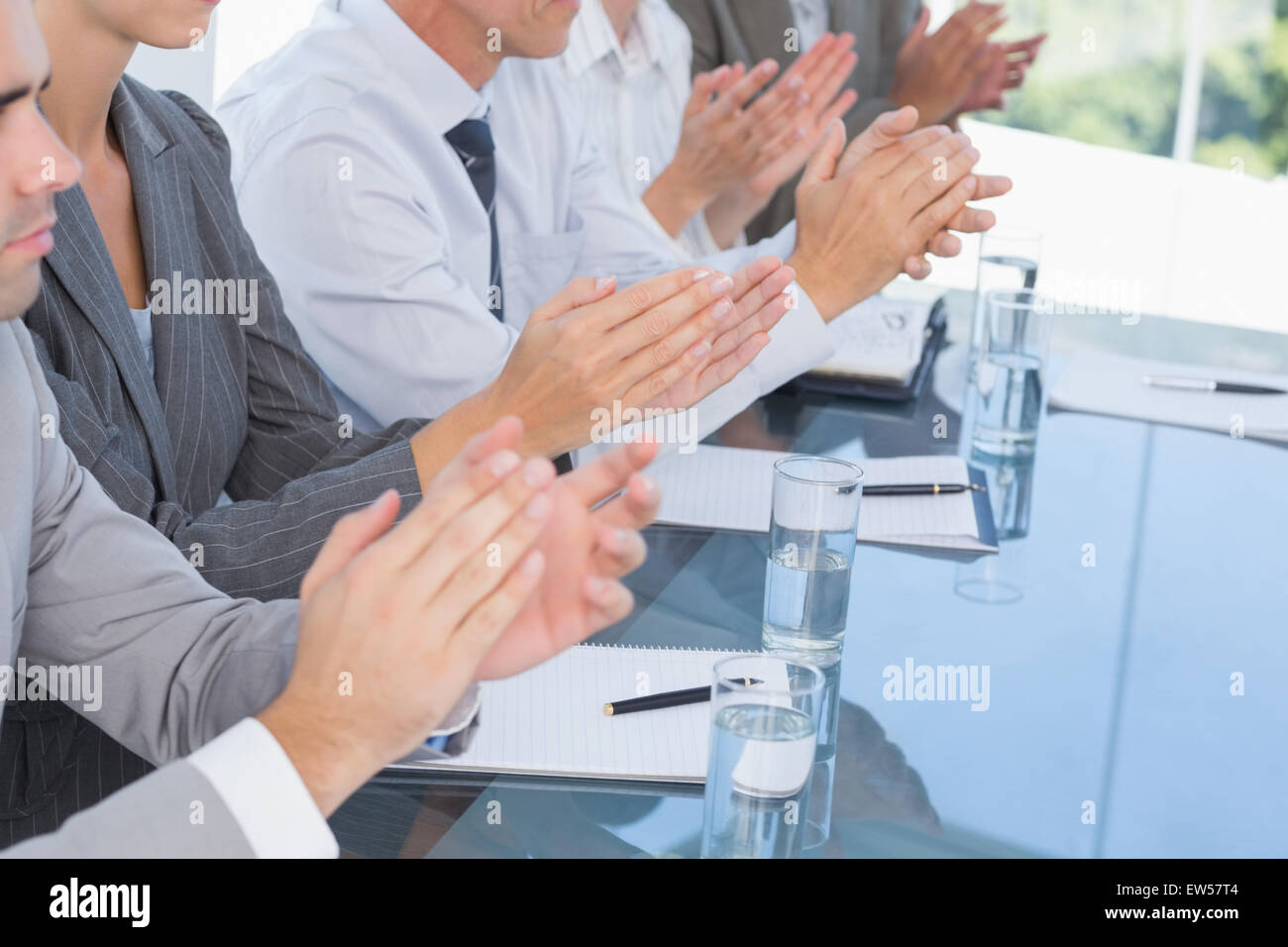 Business team applauding during conference Stock Photo
