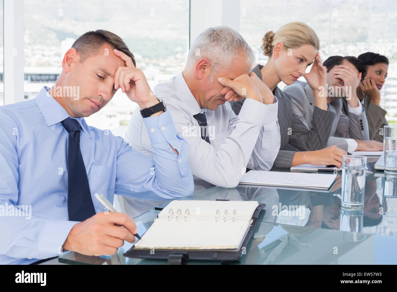 Tired business team at conference Stock Photo