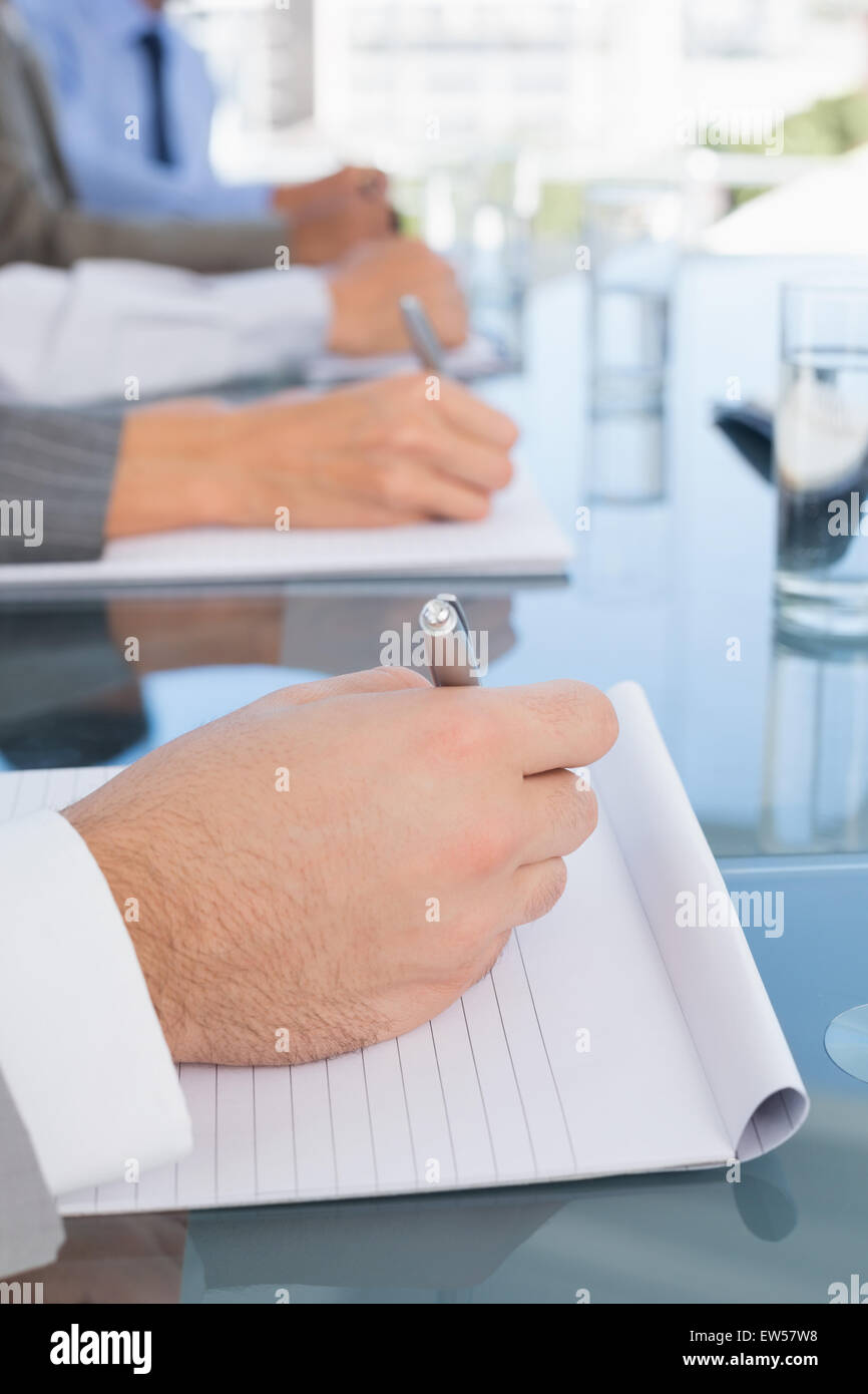 Business team taking notes during conference Stock Photo
