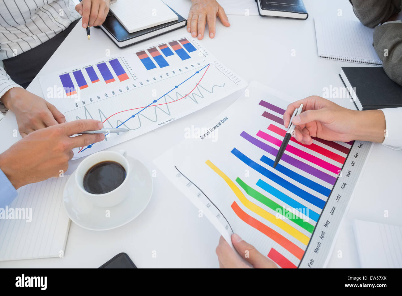 Business team analyzing bar chart graphs Stock Photo