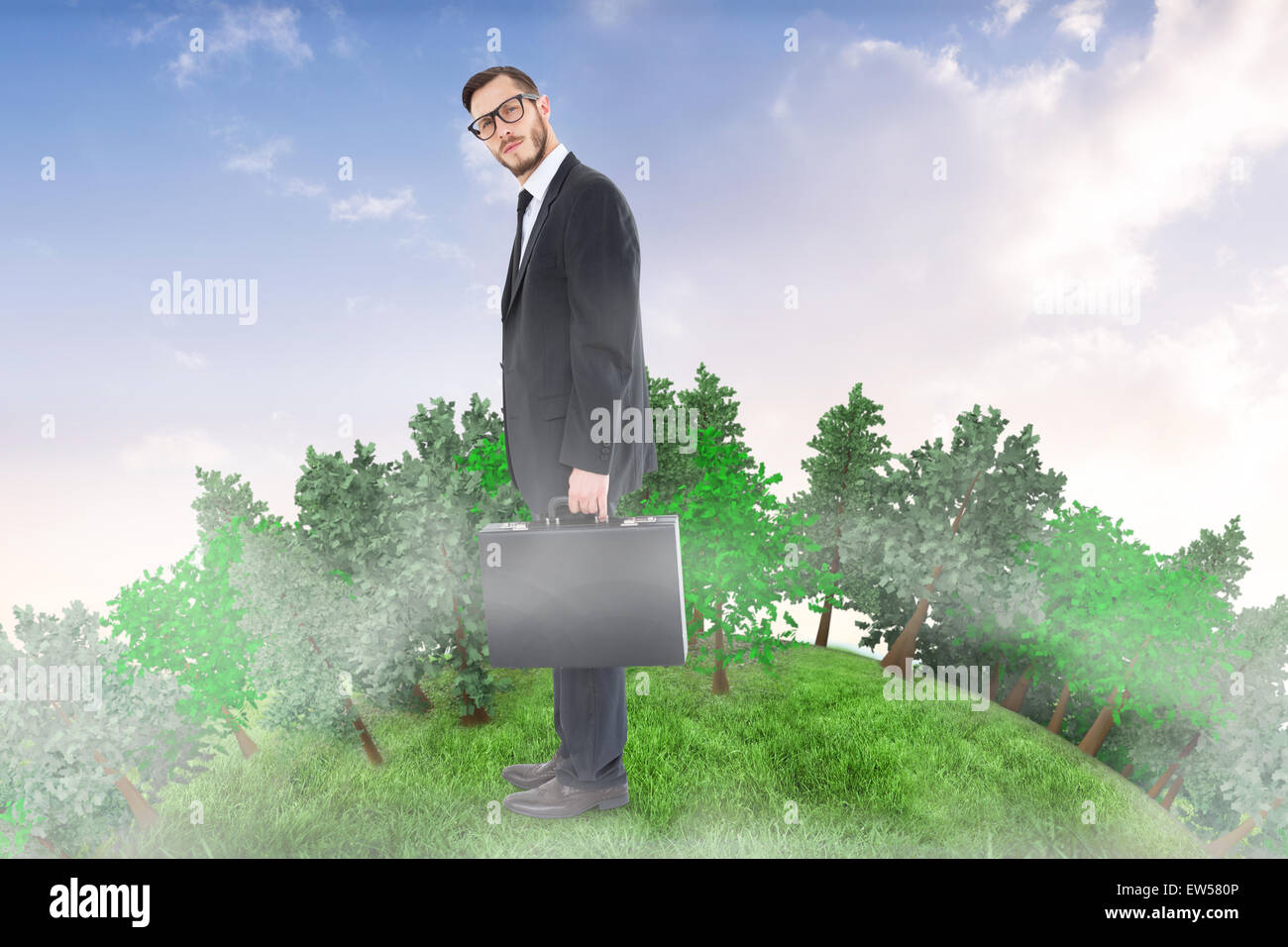 Composite image of geeky businessman holding his briefcase Stock Photo ...