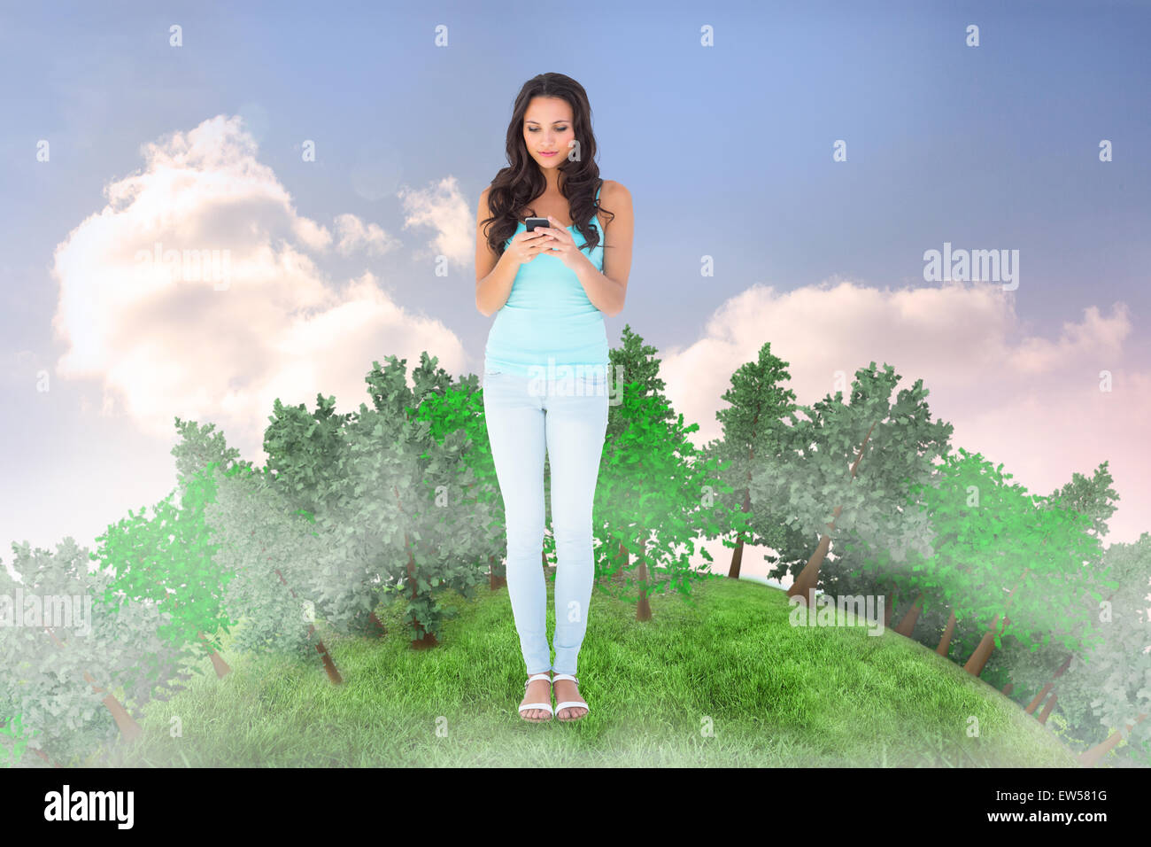 Composite image of casual brunette sending a text Stock Photo