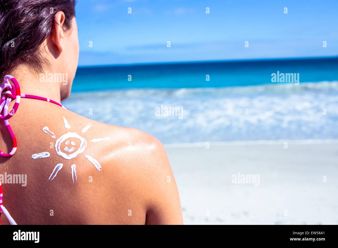 Brunette with sun tan lotion on her shoulder Stock Photo
