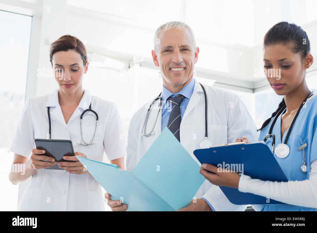 Doctors working together on patients file Stock Photo