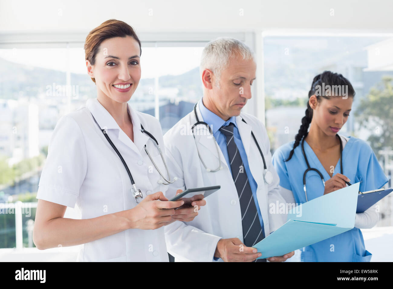 Doctors working together on patients file Stock Photo
