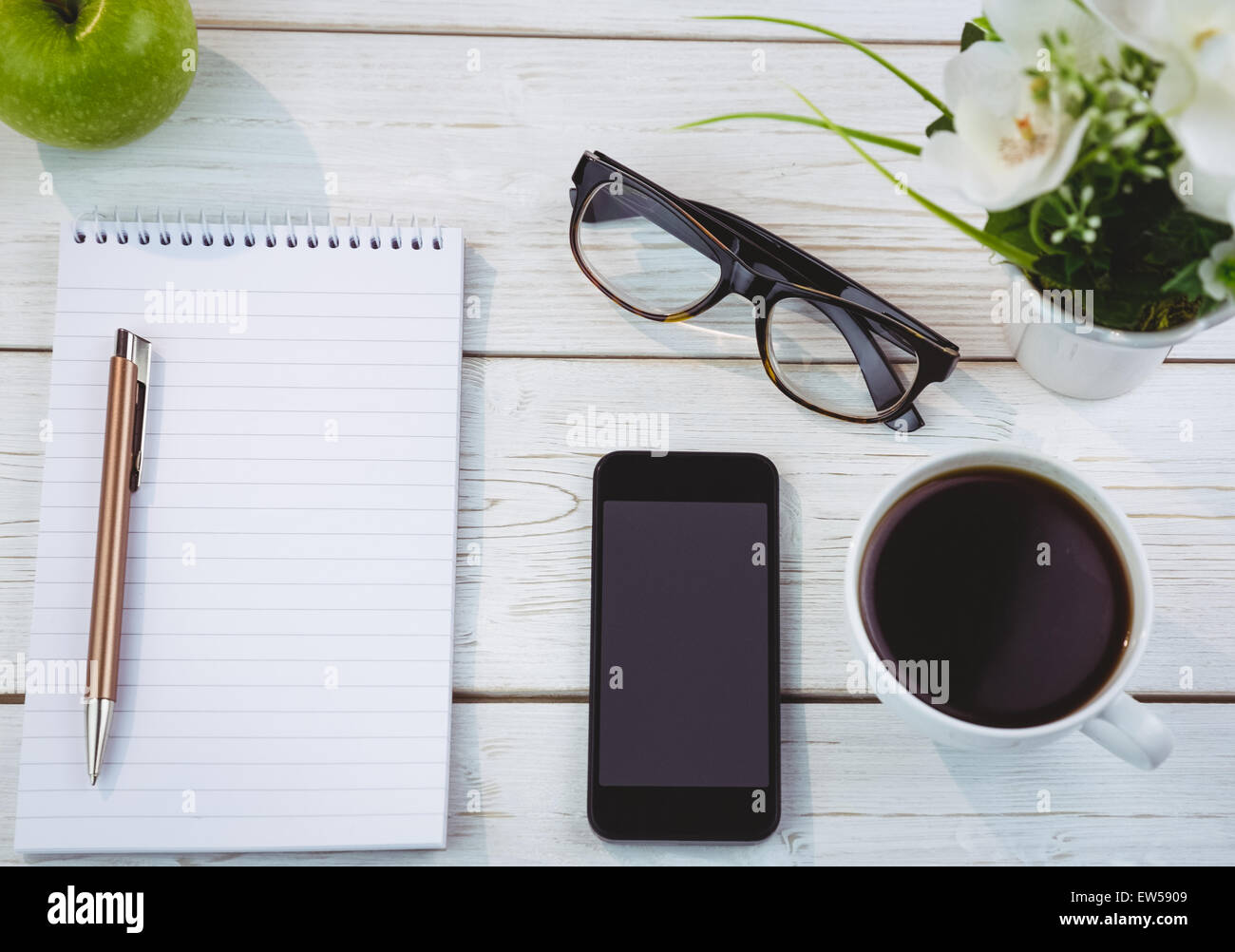 Overhead shot of notepad and smartphone Stock Photo - Alamy