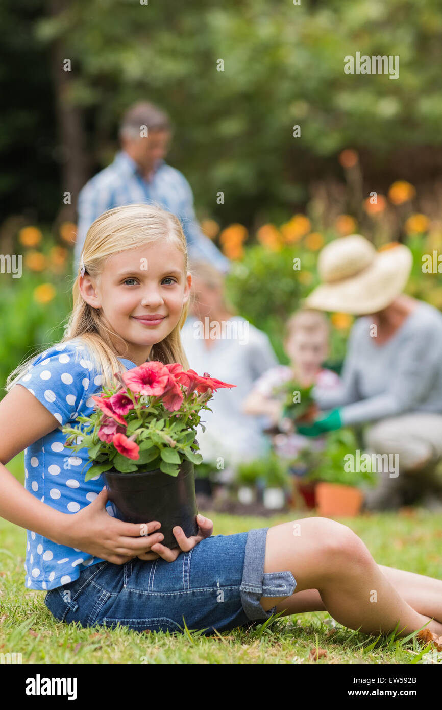 Young girl sitting with flower pot Stock Photo - Alamy