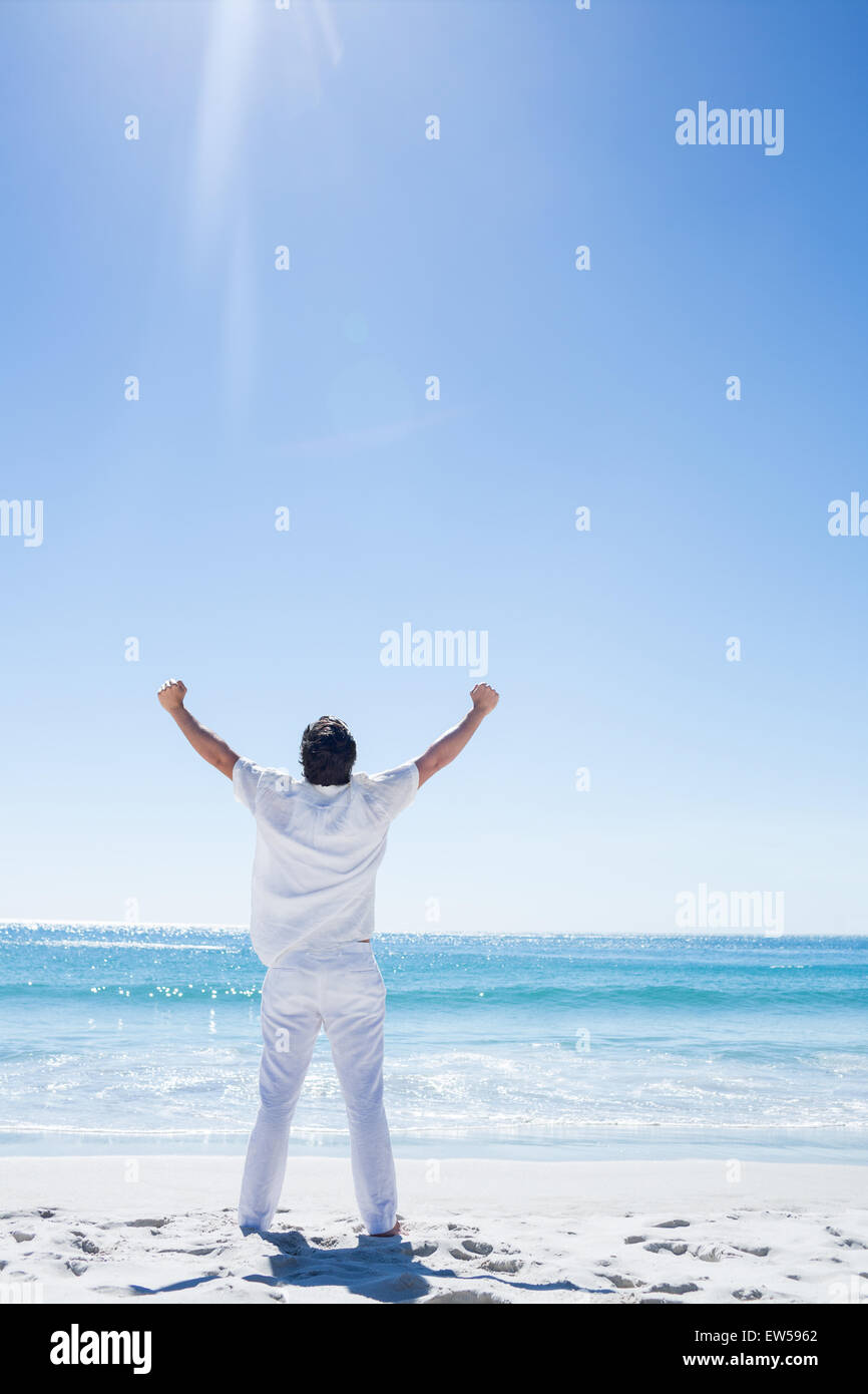 Man stretching his arms in front of the sea Stock Photo