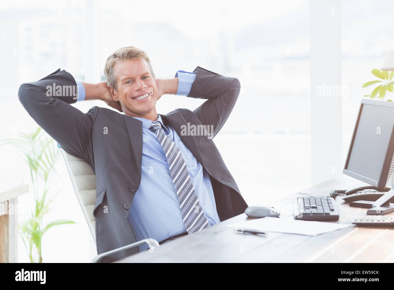 Smiling businessman looking at camera Stock Photo - Alamy