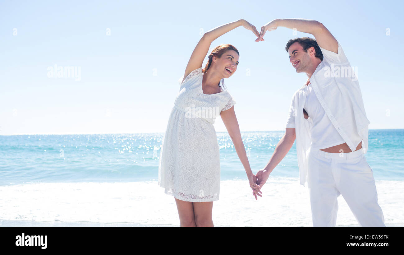 Happy couple forming heart shape with their hands Stock Photo - Alamy