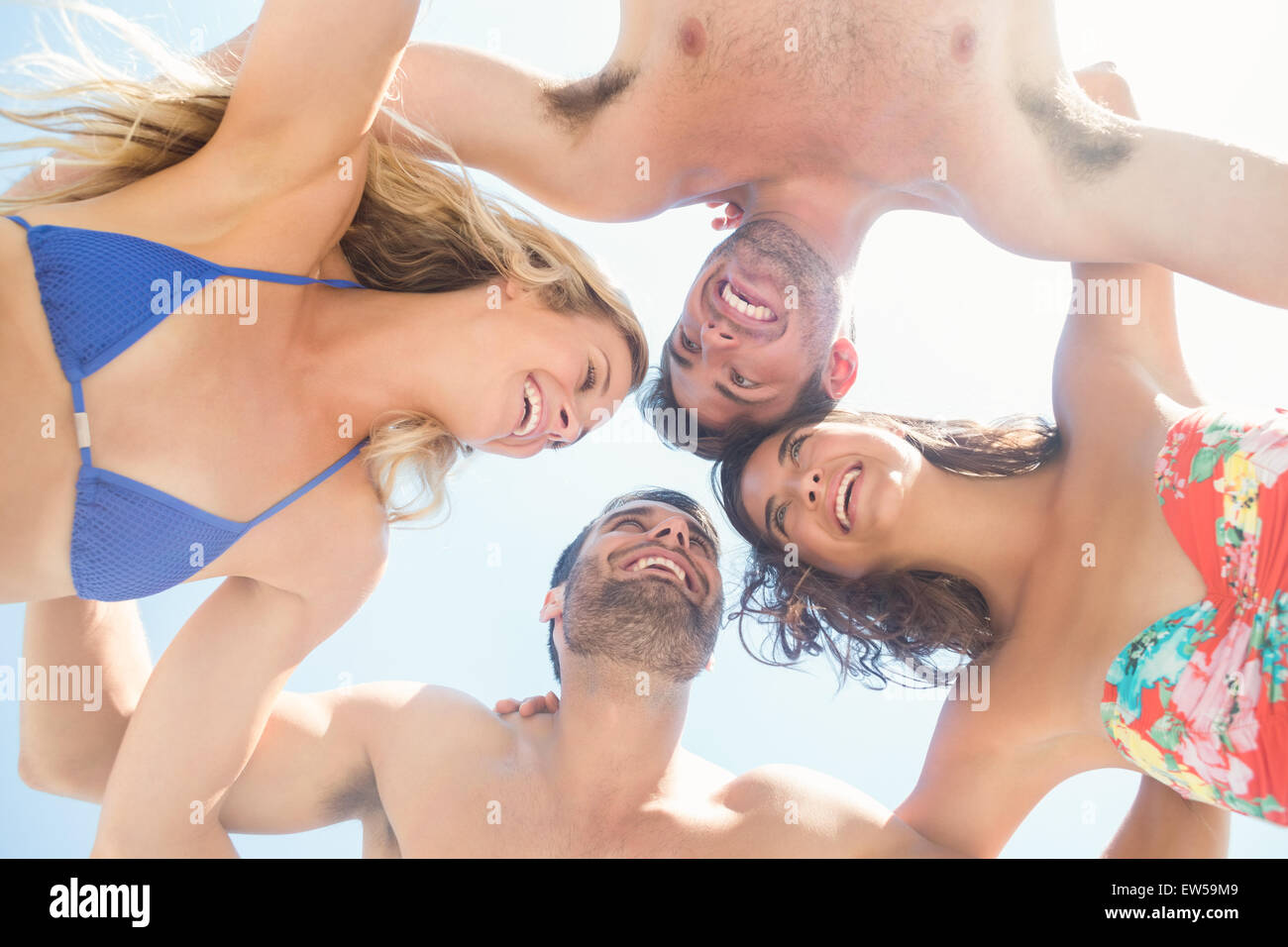 group of friends in swimsuits smiling at each others Stock Photo