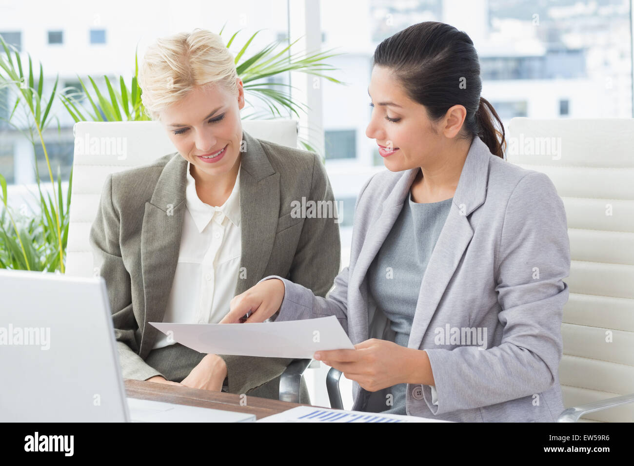 Businesswomen reading files Stock Photo