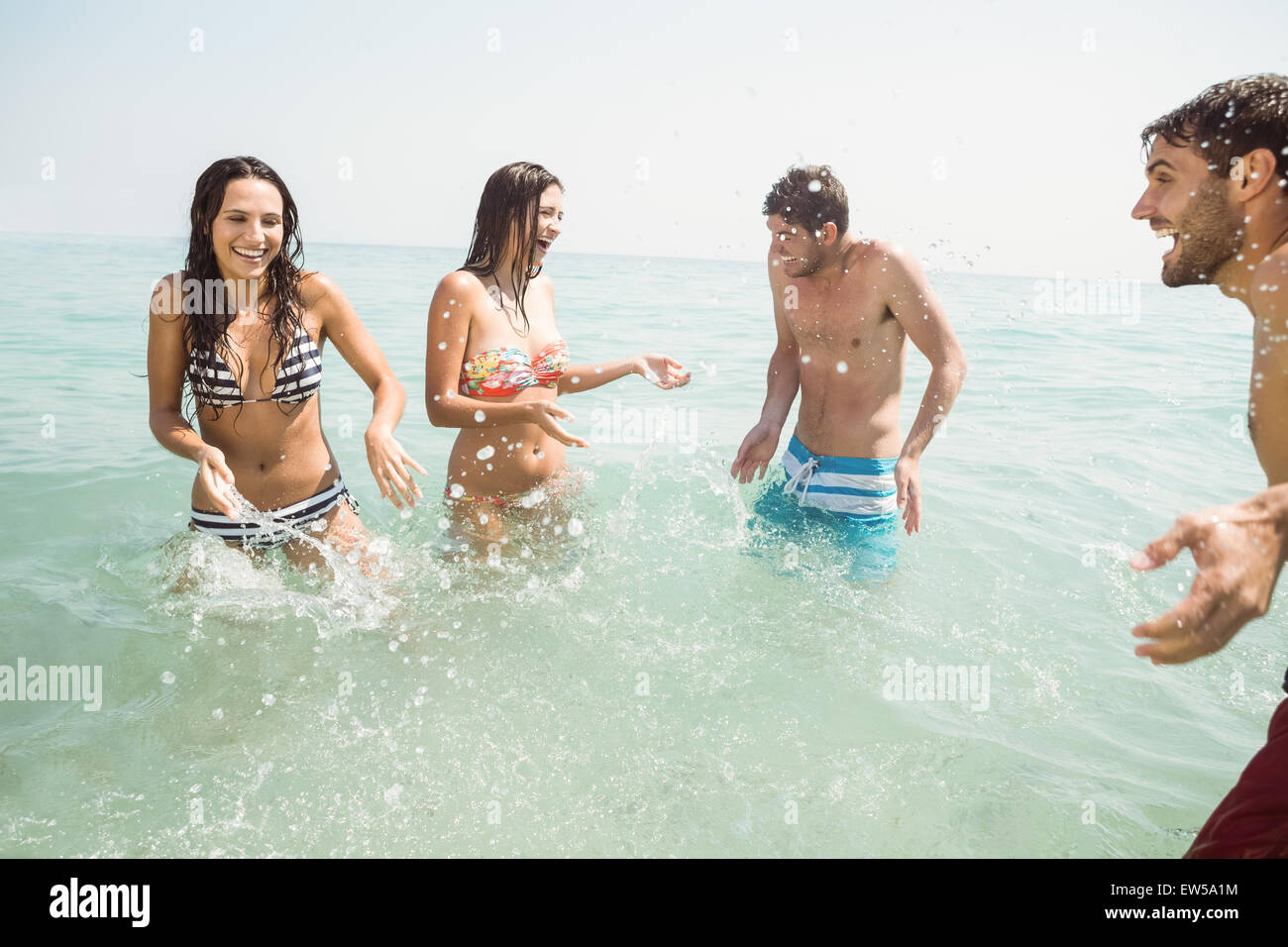 group of friends in swimsuits having fun on the sea Stock Photo