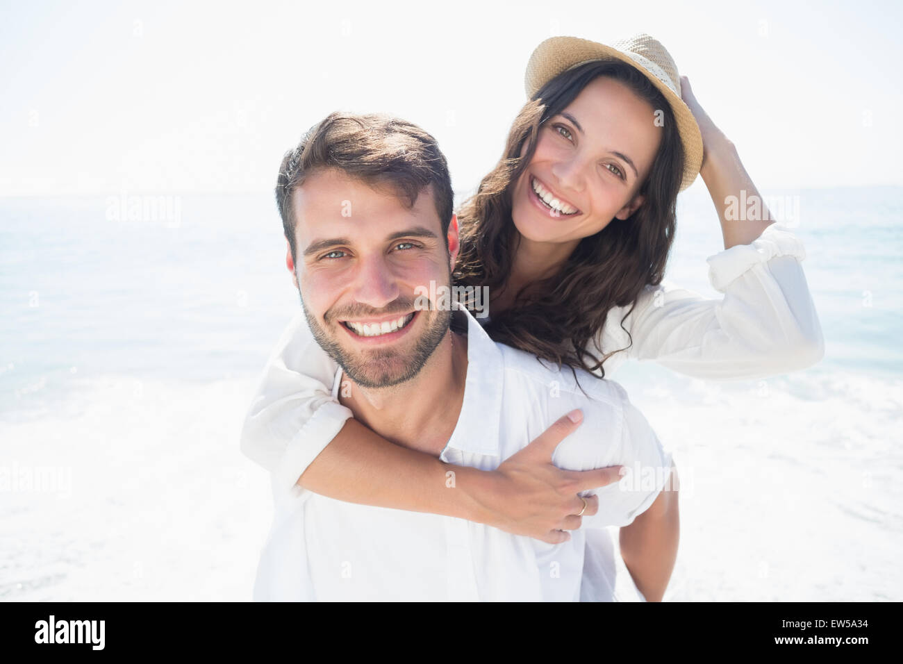 Handsome man doing piggy-back to his girlfriend Stock Photo