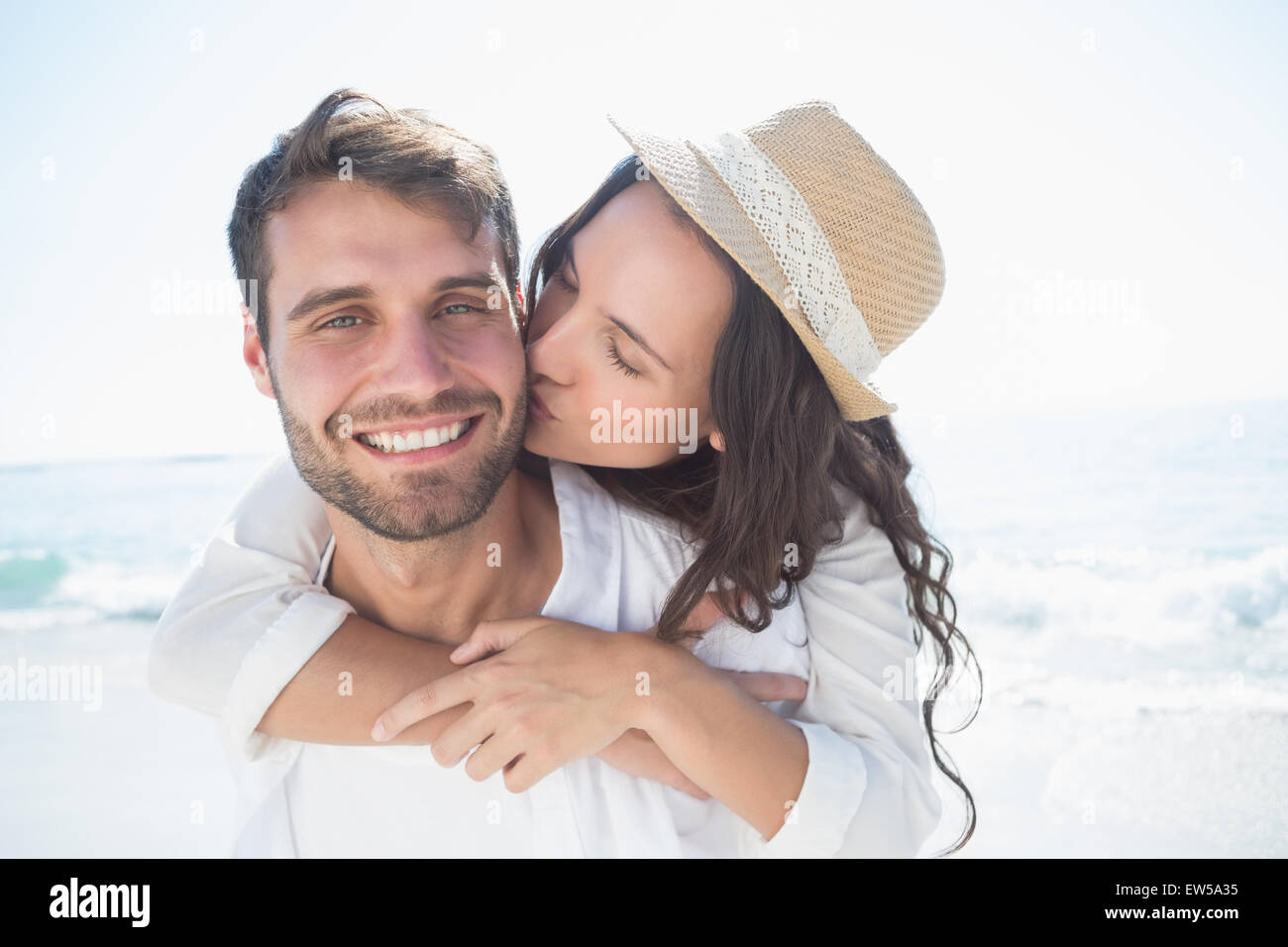 Handsome man doing piggy-back to his girlfriend Stock Photo