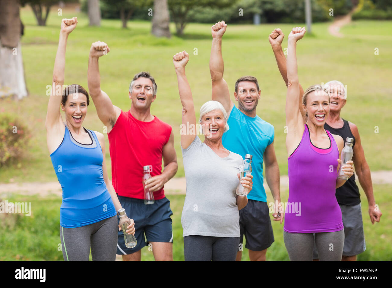 Happy athletic group holding up their fist Stock Photo Alamy