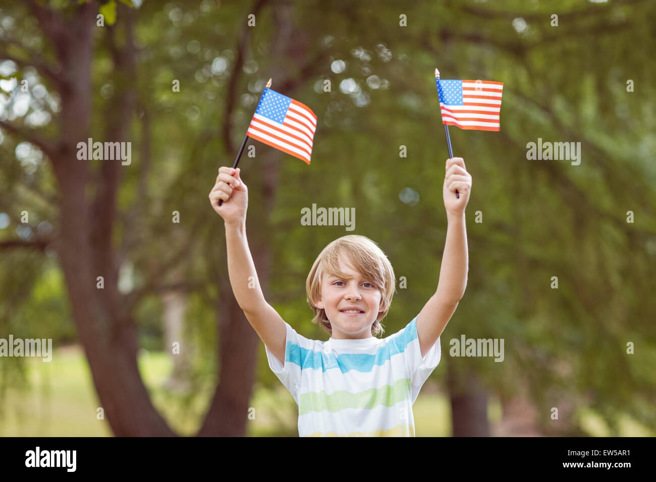 Young boy holding an american flag Stock Photo - Alamy