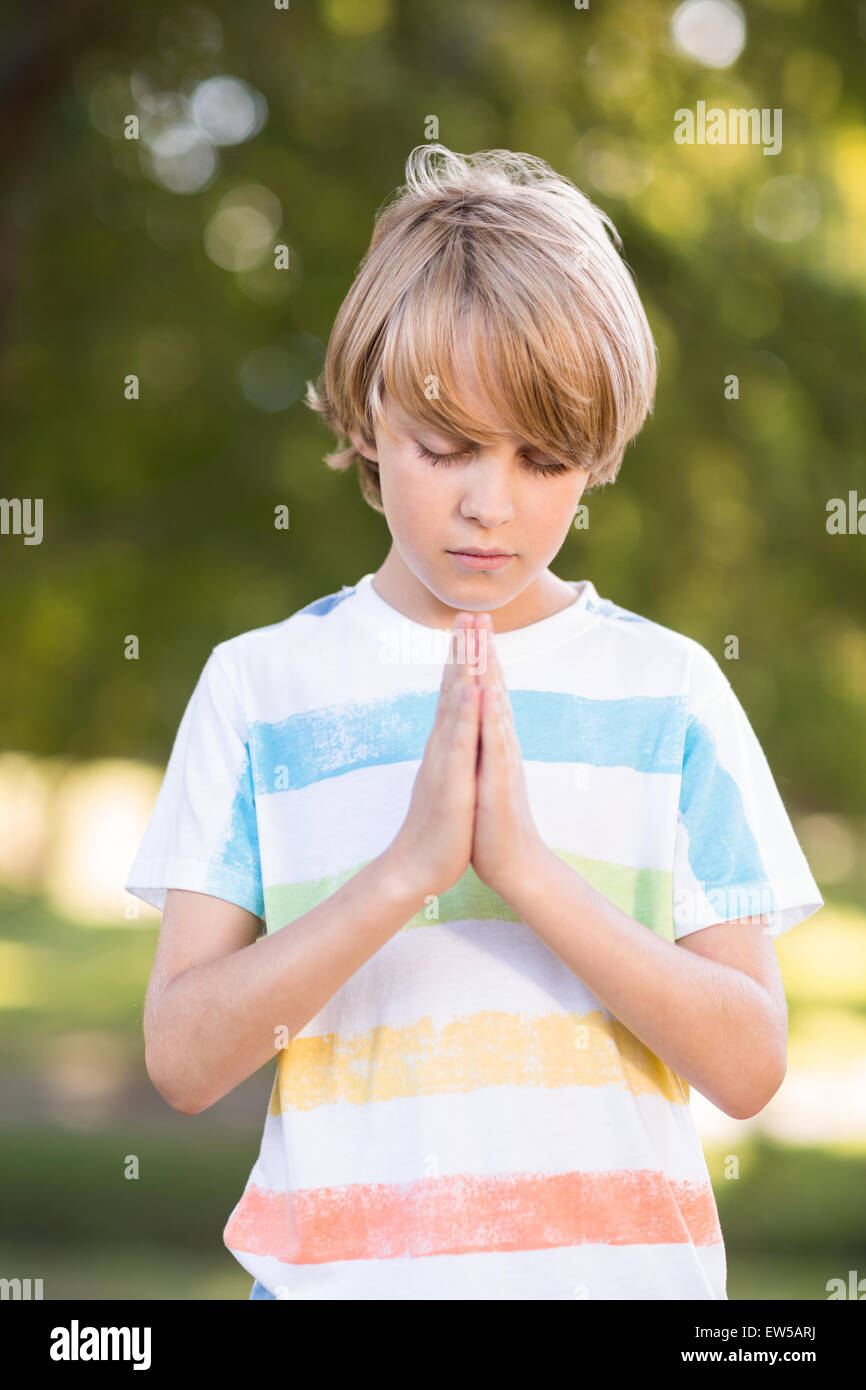 Little boy saying his prayers Stock Photo
