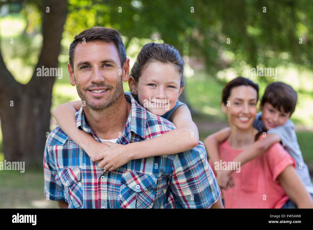 Happy family in the park together Stock Photo - Alamy