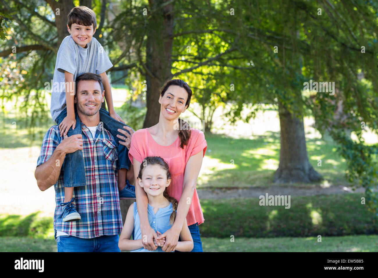 Happy family in the park together Stock Photo - Alamy