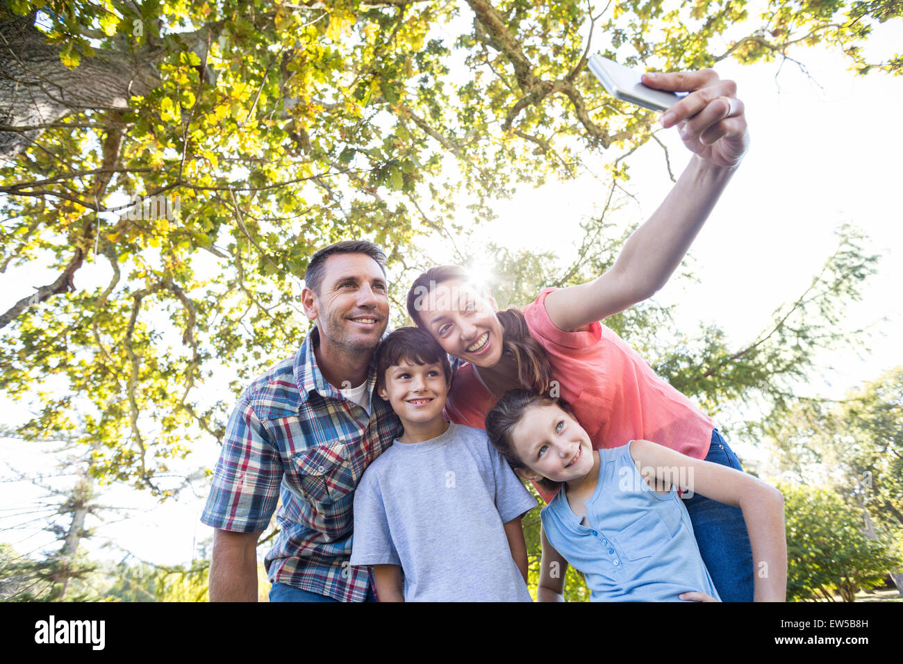 Happy family in the park taking selfie Stock Photo - Alamy