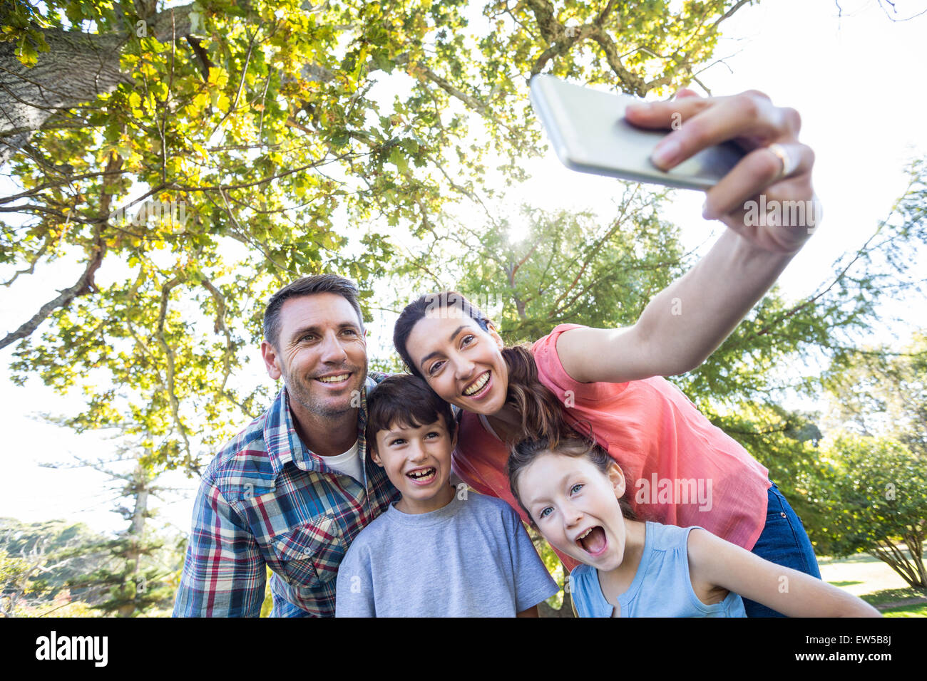 Happy family in the park taking selfie Stock Photo - Alamy