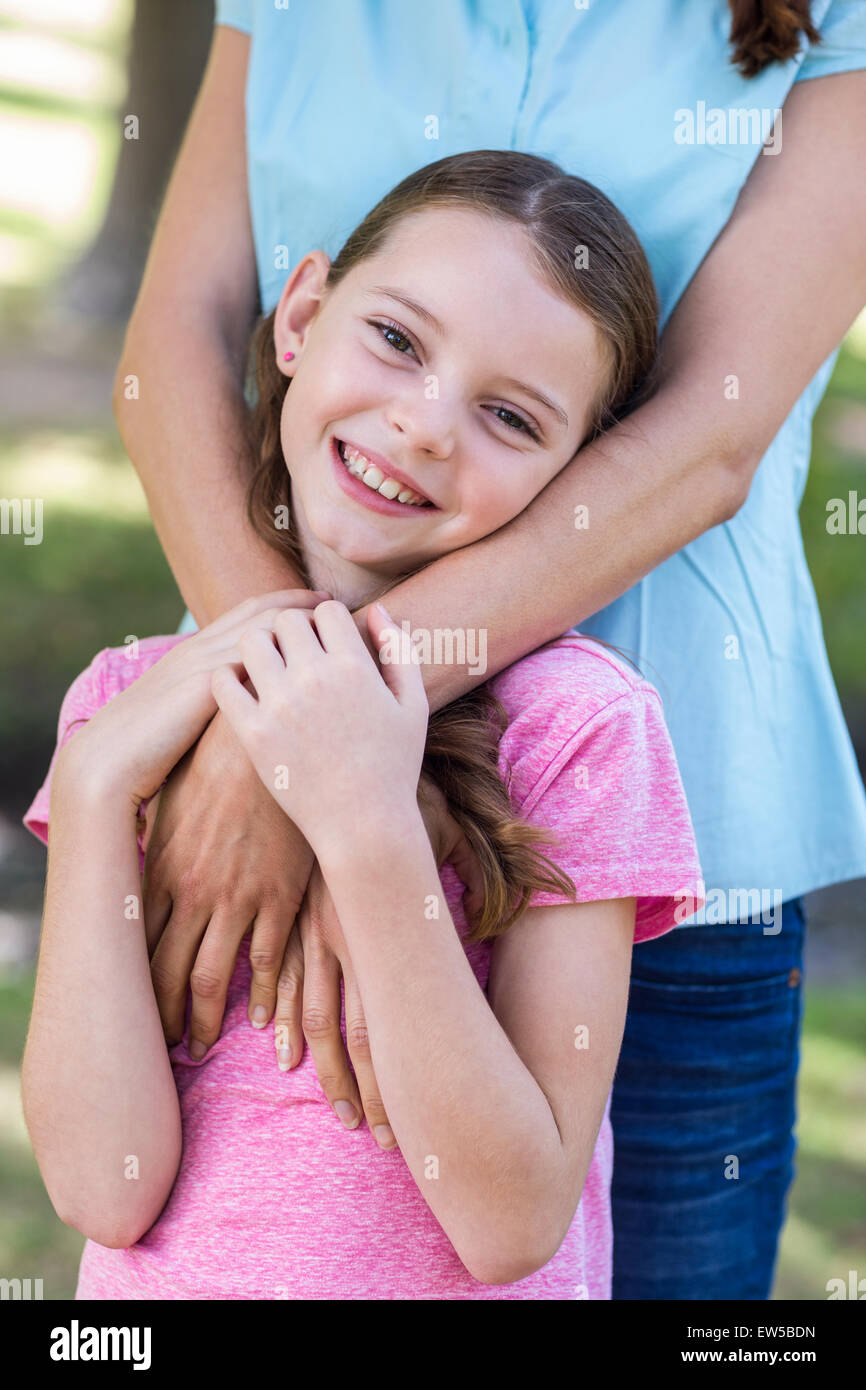 Happy mother and daughter smiling at the camera Stock Photo