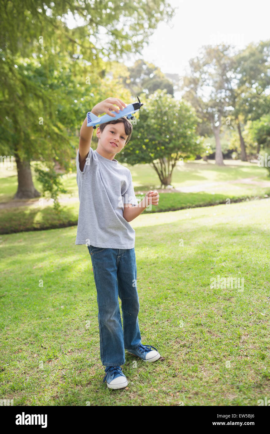 Boy playing with a toy plane at park Stock Photo - Alamy
