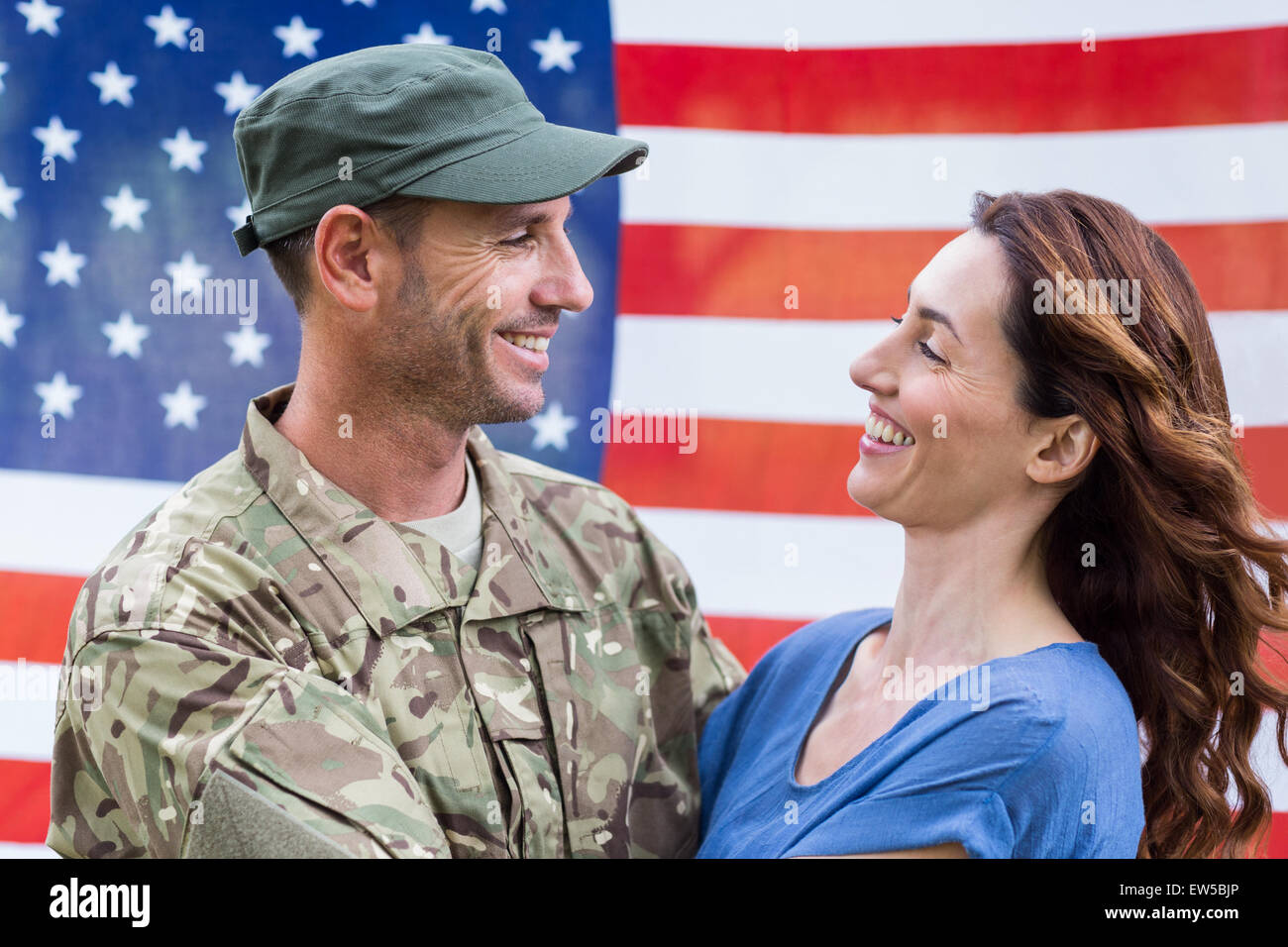 Handsome soldier reunited with partner Stock Photo