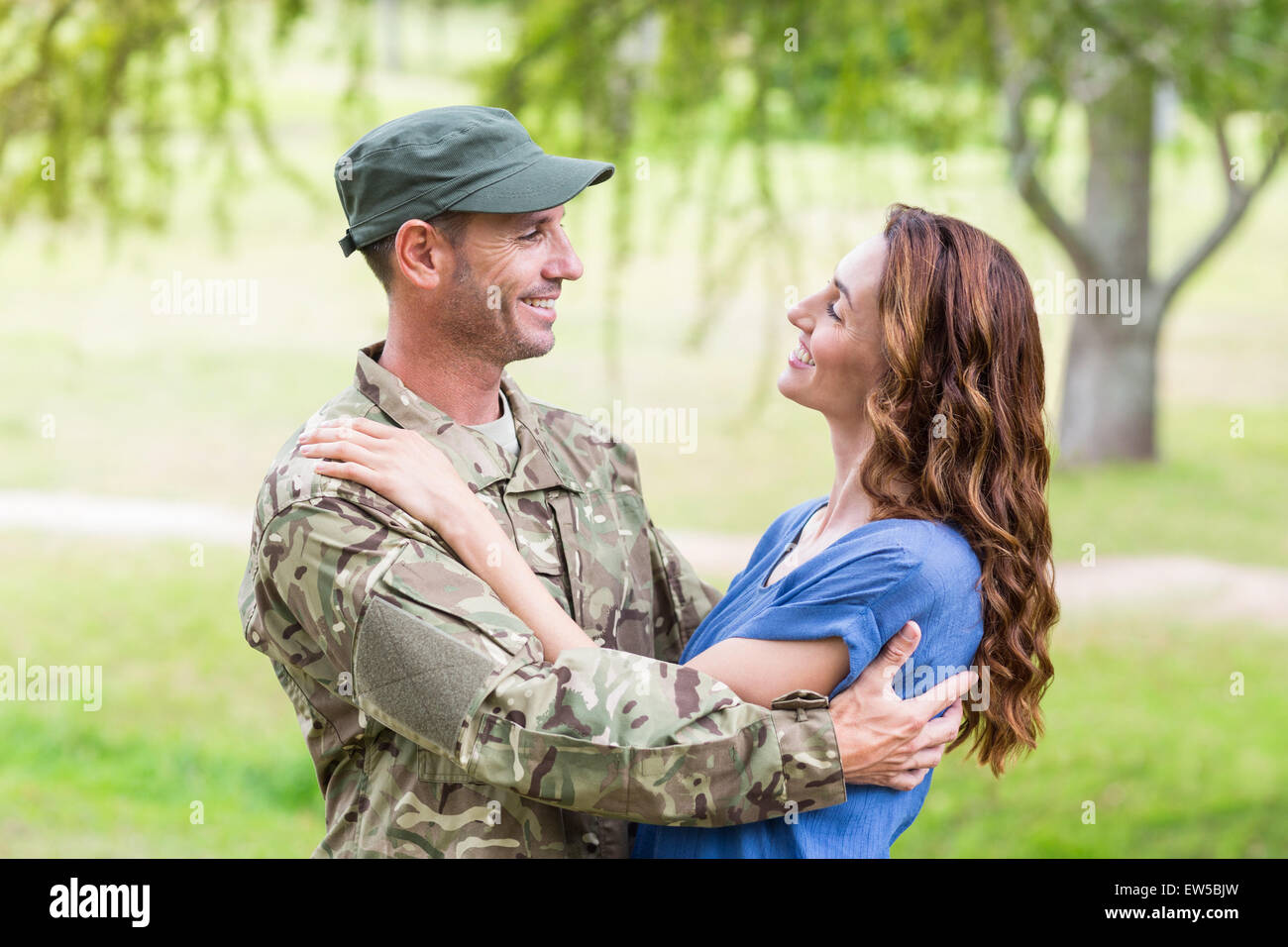 Handsome soldier reunited with partner Stock Photo