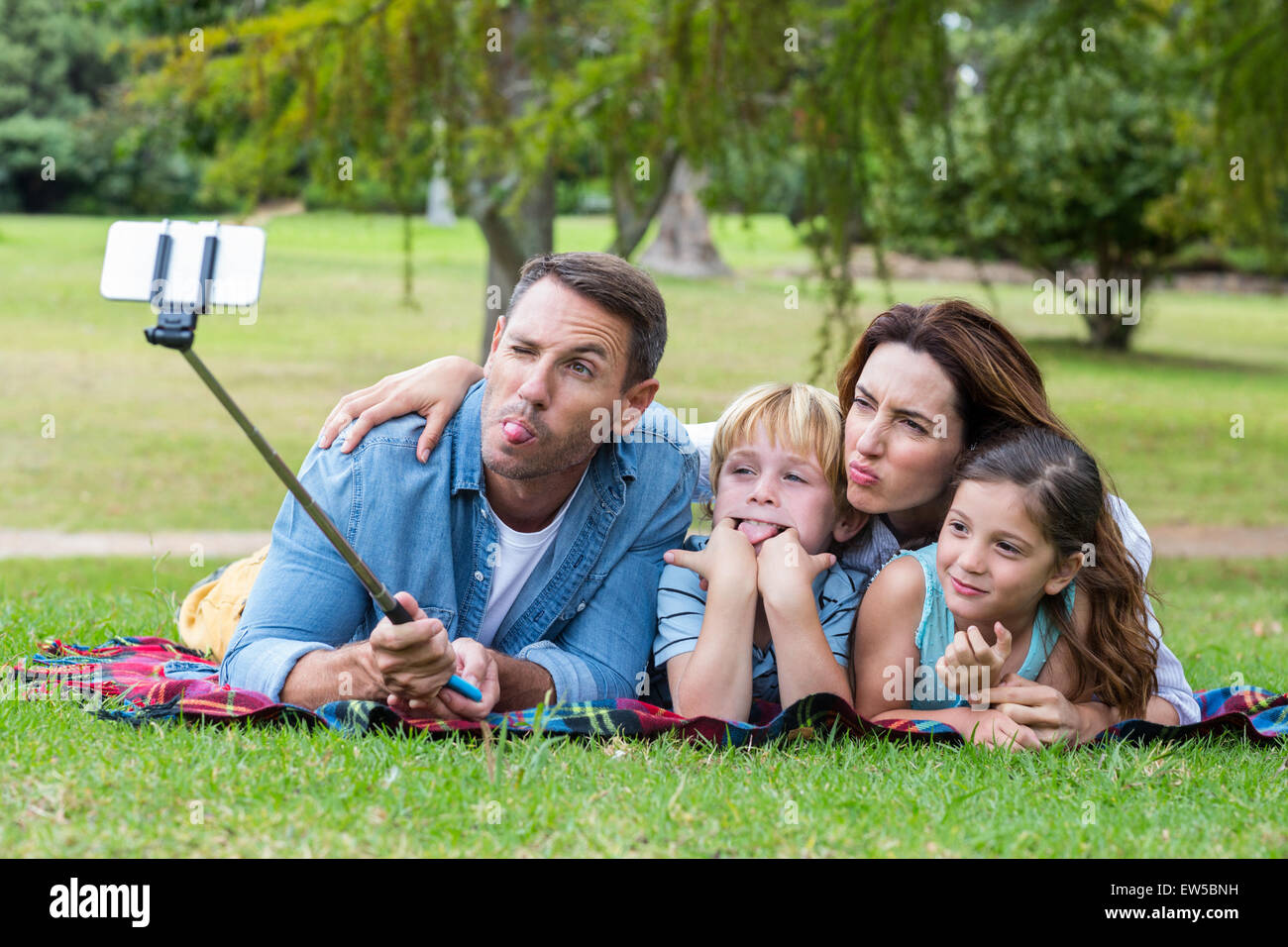 Happy family in the park taking selfie Stock Photo - Alamy