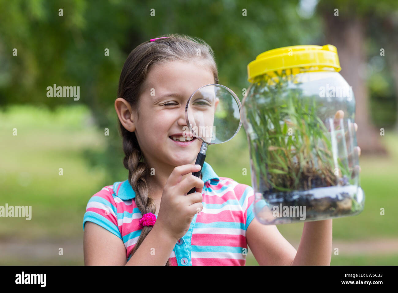 Curious little girl looking at jar Stock Photo