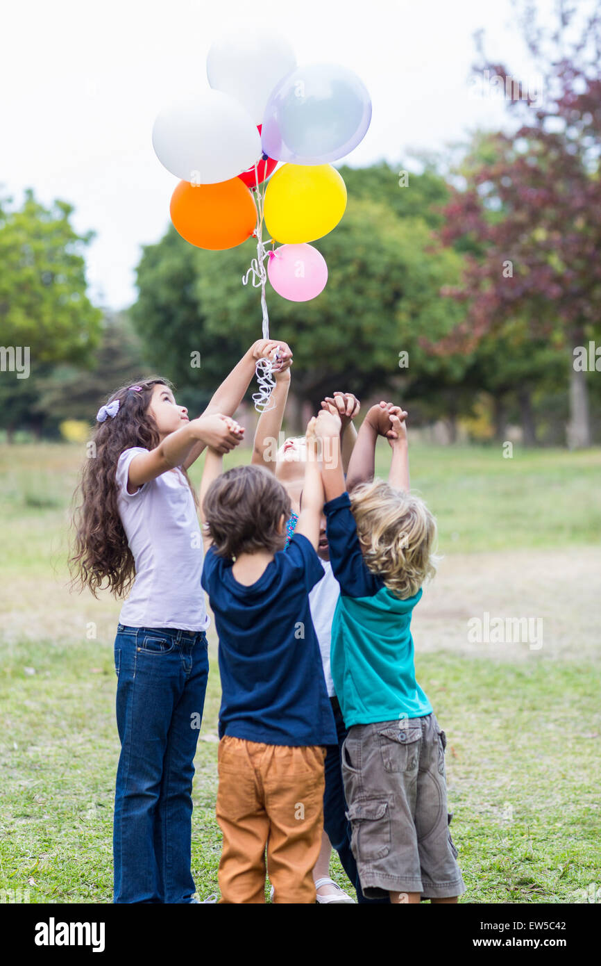 Happy children holding balloons Stock Photo
