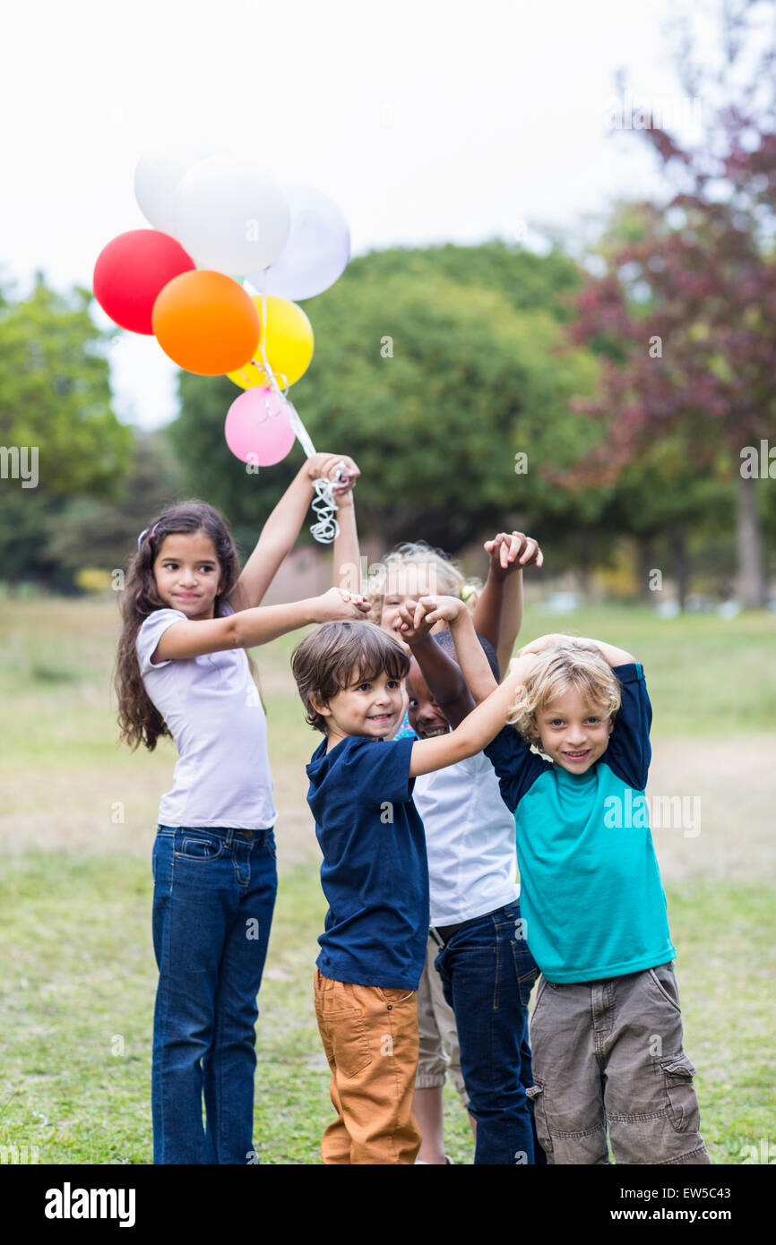 Happy children holding balloons Stock Photo