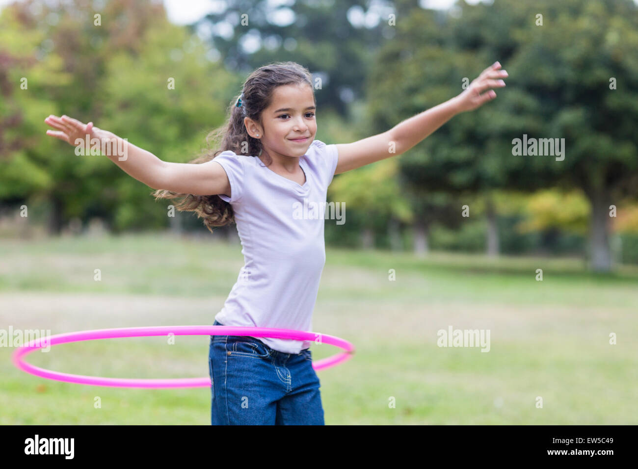happy girl playing with hula hoops Stock Photo