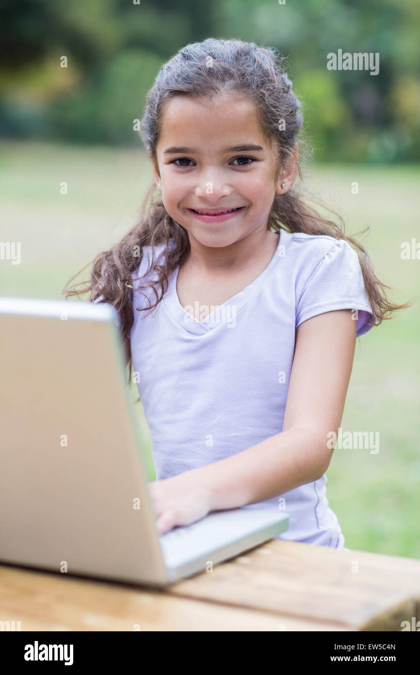 Little girl using her laptop Stock Photo