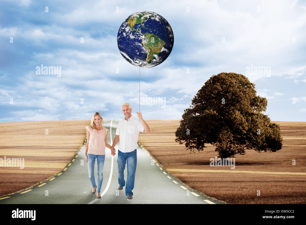 Composite image of happy couple walking holding hands Stock Photo