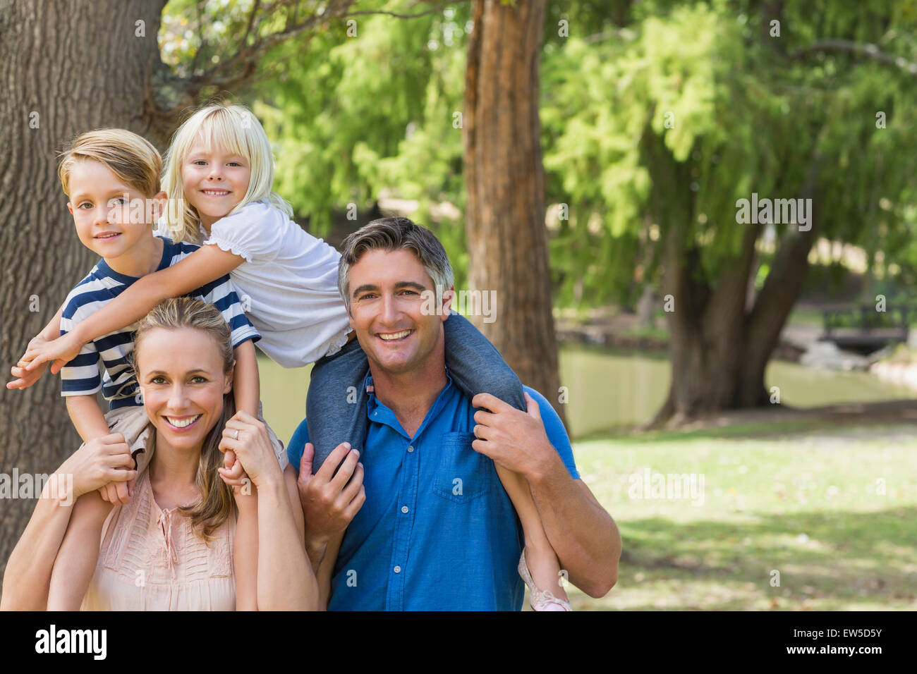 Happy family playing in the park together Stock Photo - Alamy