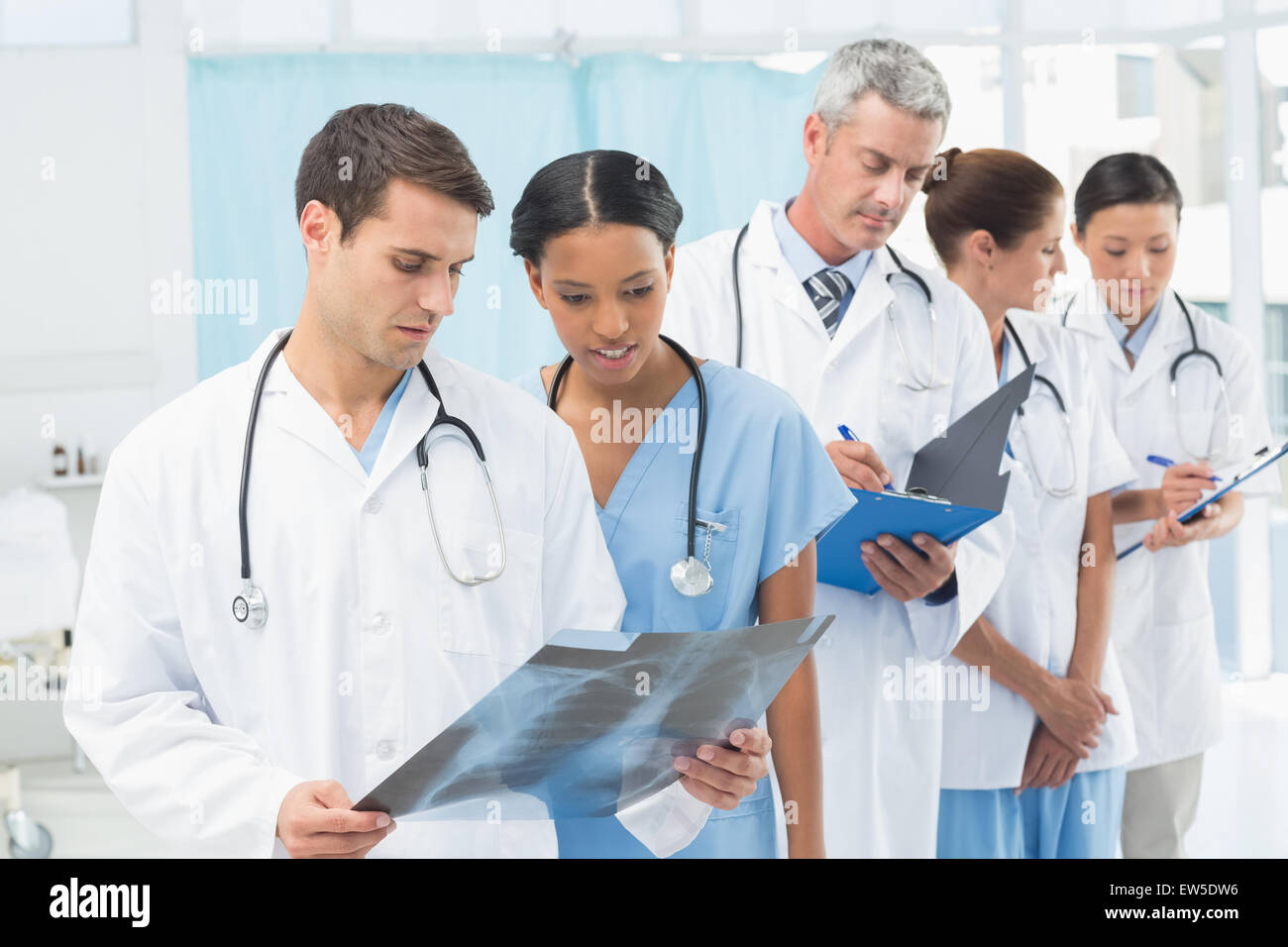 Male and female doctors examining x-ray Stock Photo
