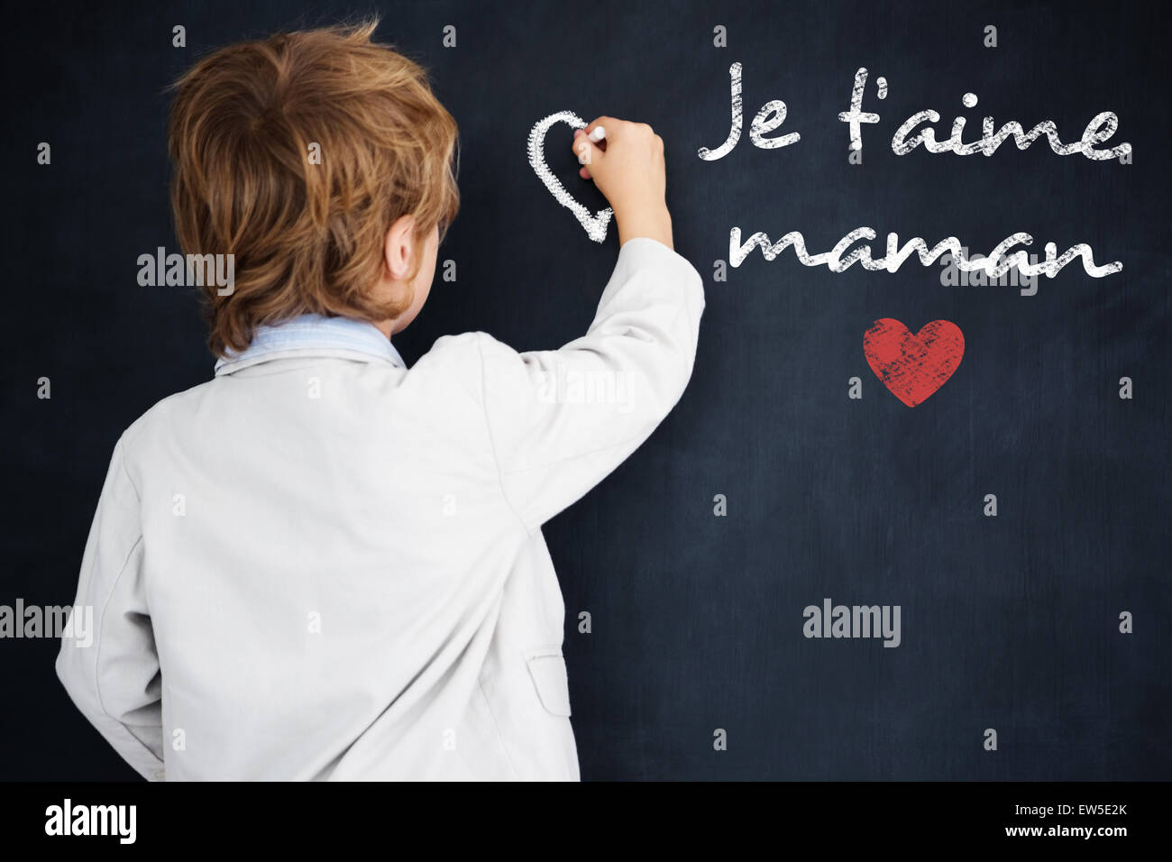 Composite image of cute pupil writing on board Stock Photo