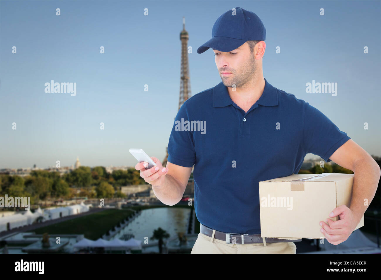 Composite image of delivery man using mobile phone while holding package Stock Photo